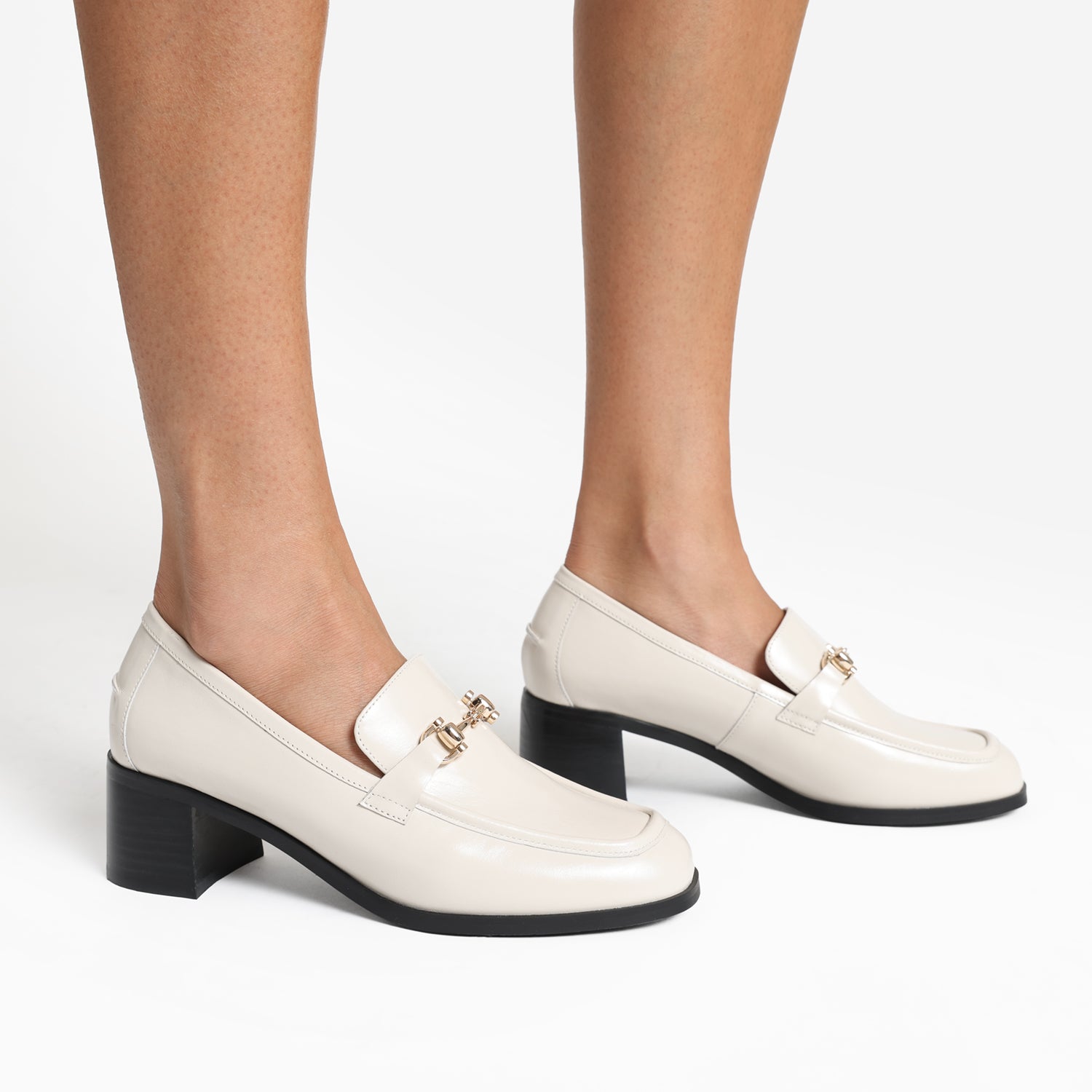 Bremen loafer in ivory leather with 4.5cm black block heel and gold feminine hardware.