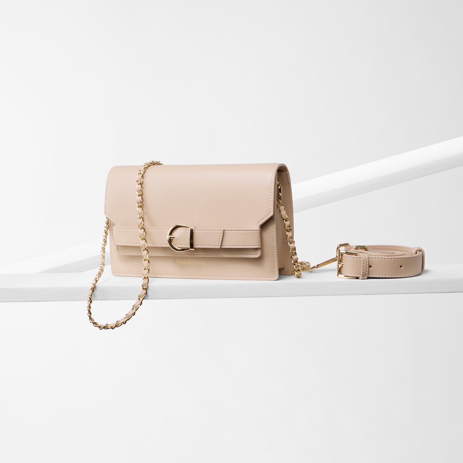 Capri nude leather crossbody handbag with two strap options: leather and metal straps. Gold hardware.